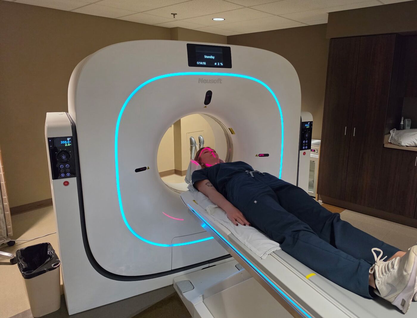 The CT scanner in the imaging department at Washington County Hospital, with a person positioned on the table and the alignment lasers on